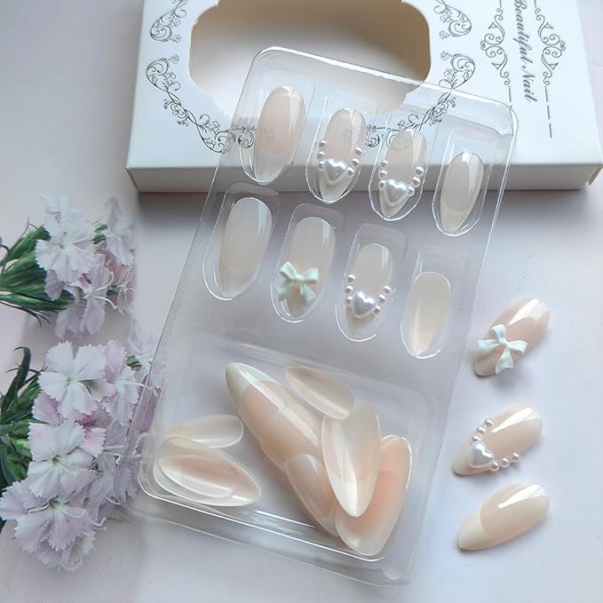 24Pcs White French Tip Press on Nails Medium Almond Fake Nails with Glitter Heart Nail Charms Acrylic Nails Cute Pearls Bow Full Cover False Nails Nude Pink Glue on Nails for Women DIY Stick on Nails