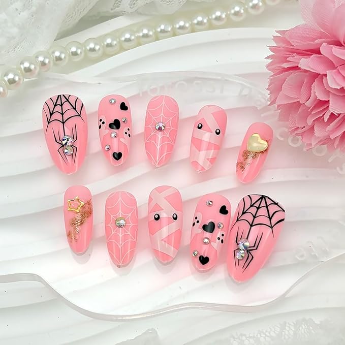 24Pcs Halloween Press on Nails Medium Almond Fake Nails with Cute Ghost Spider Web Mummy Design Pink Stick on Nails Silver Glitter Rhinestones False Nails Full Cover Artificial Glue on Nail for Women