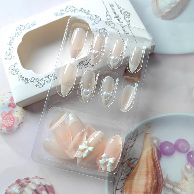 24Pcs White French Tip Press on Nails Medium Almond Fake Nails with Glitter Heart Nail Charms Acrylic Nails Cute Pearls Bow Full Cover False Nails Nude Pink Glue on Nails for Women DIY Stick on Nails