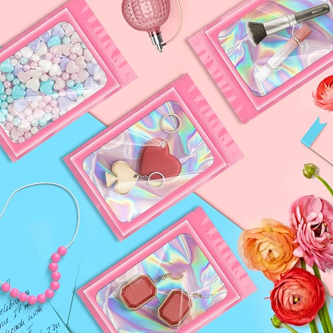 ANZNKU 100 Pack Mylar Bags Reasealable Holographic Bags, Smell Proof Bag Zipper Pouches with Clear Window, Jewelry Candy Sealable Bag for Packaging Sample Party Favor (Pink, 7.1 x 10.2 Inch)